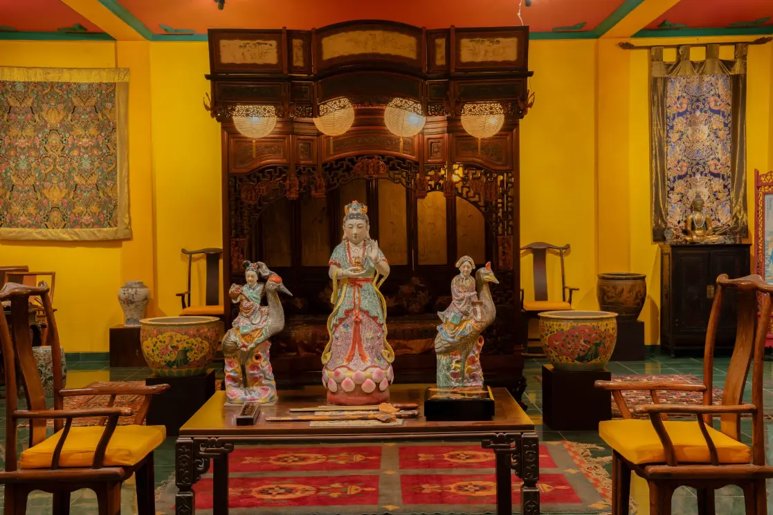 An intricately carved statue of Guan Yin, the revered Goddess of Mercy, showcasing traditional Chinese art and heritage.