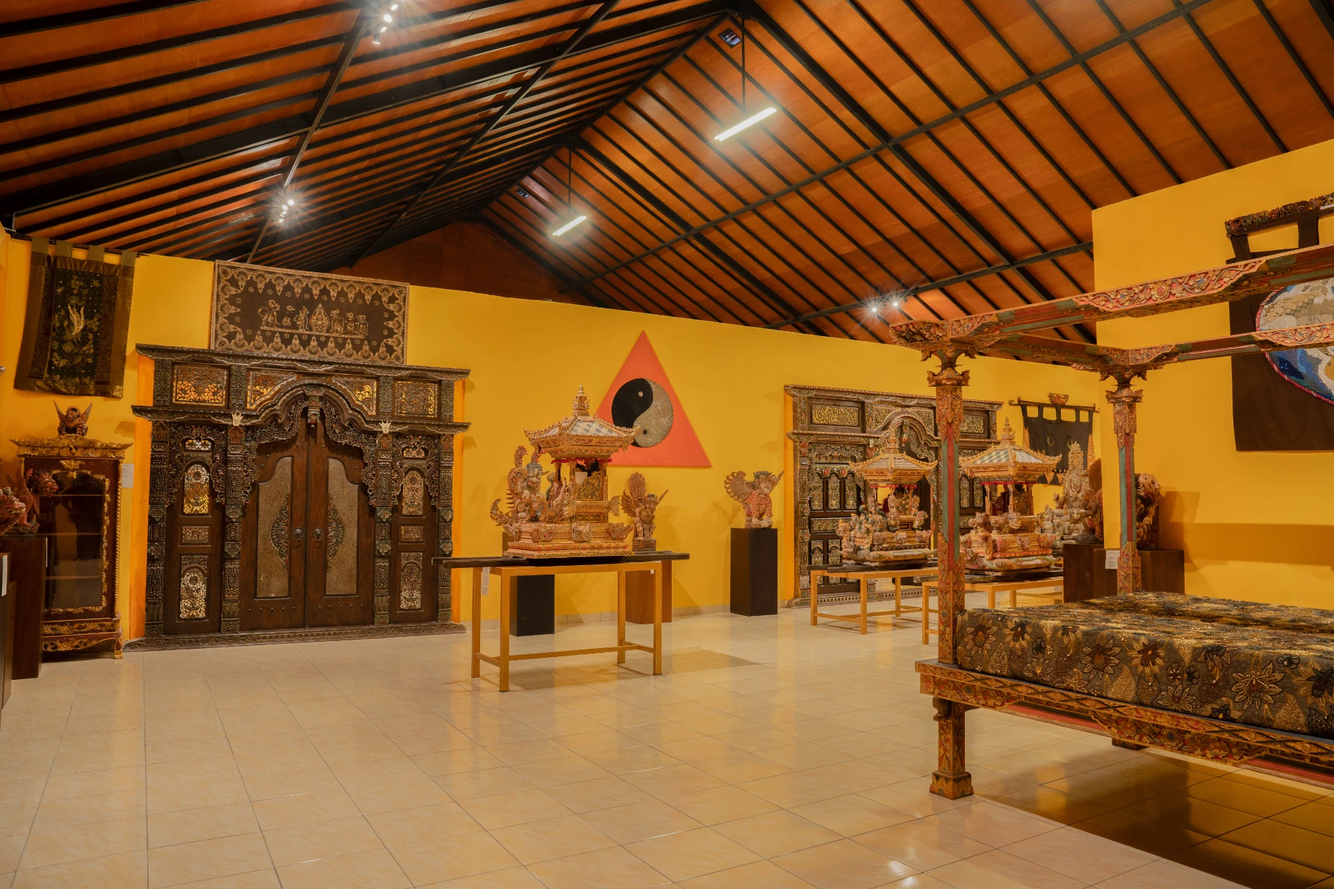 Collection of traditional Balinese textiles and ancient beaded jewelry fragments.