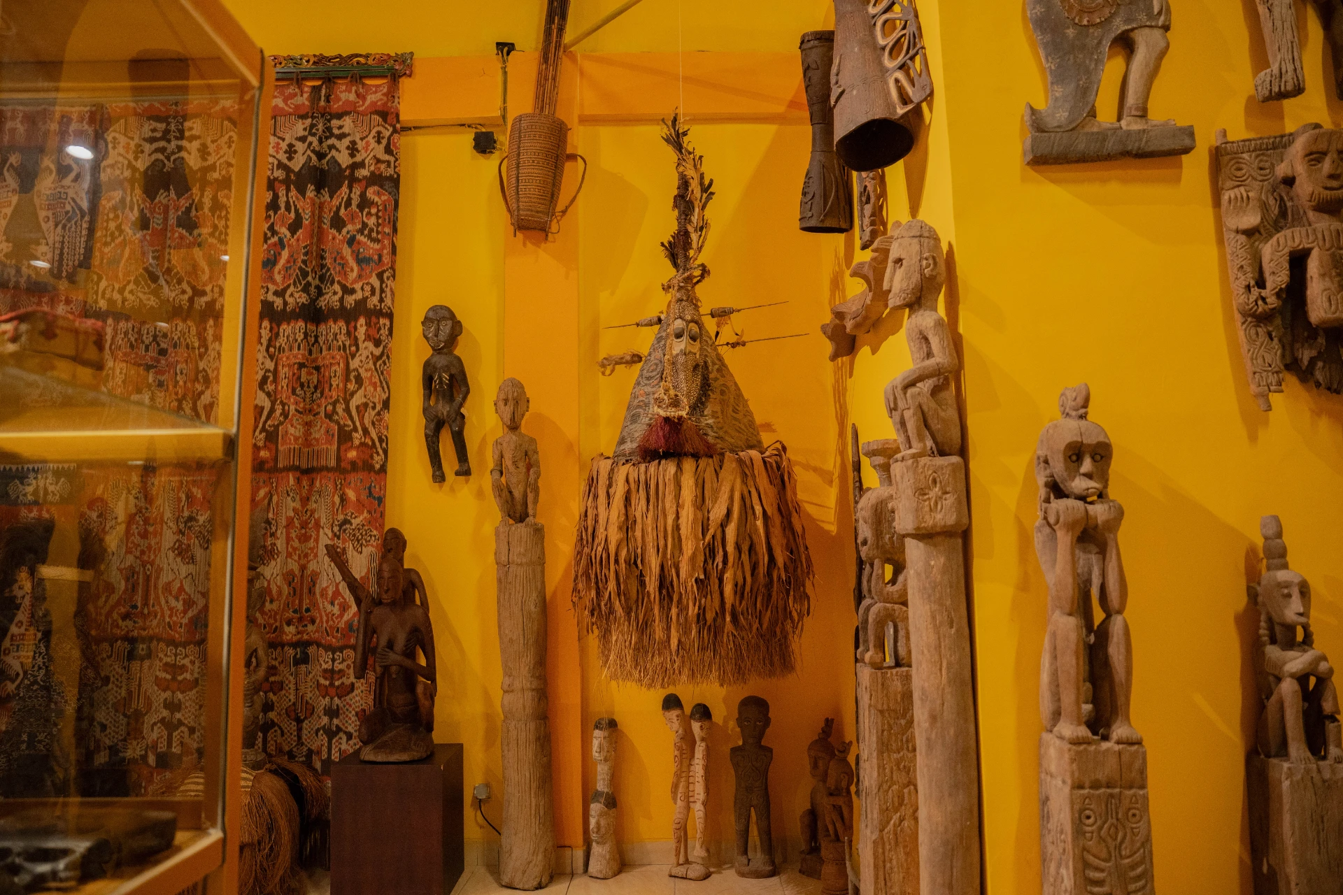 Historical Indonesian keris daggers and traditional weaponry displayed inside glass cases, Scary Room, Museum Peter Bloch.