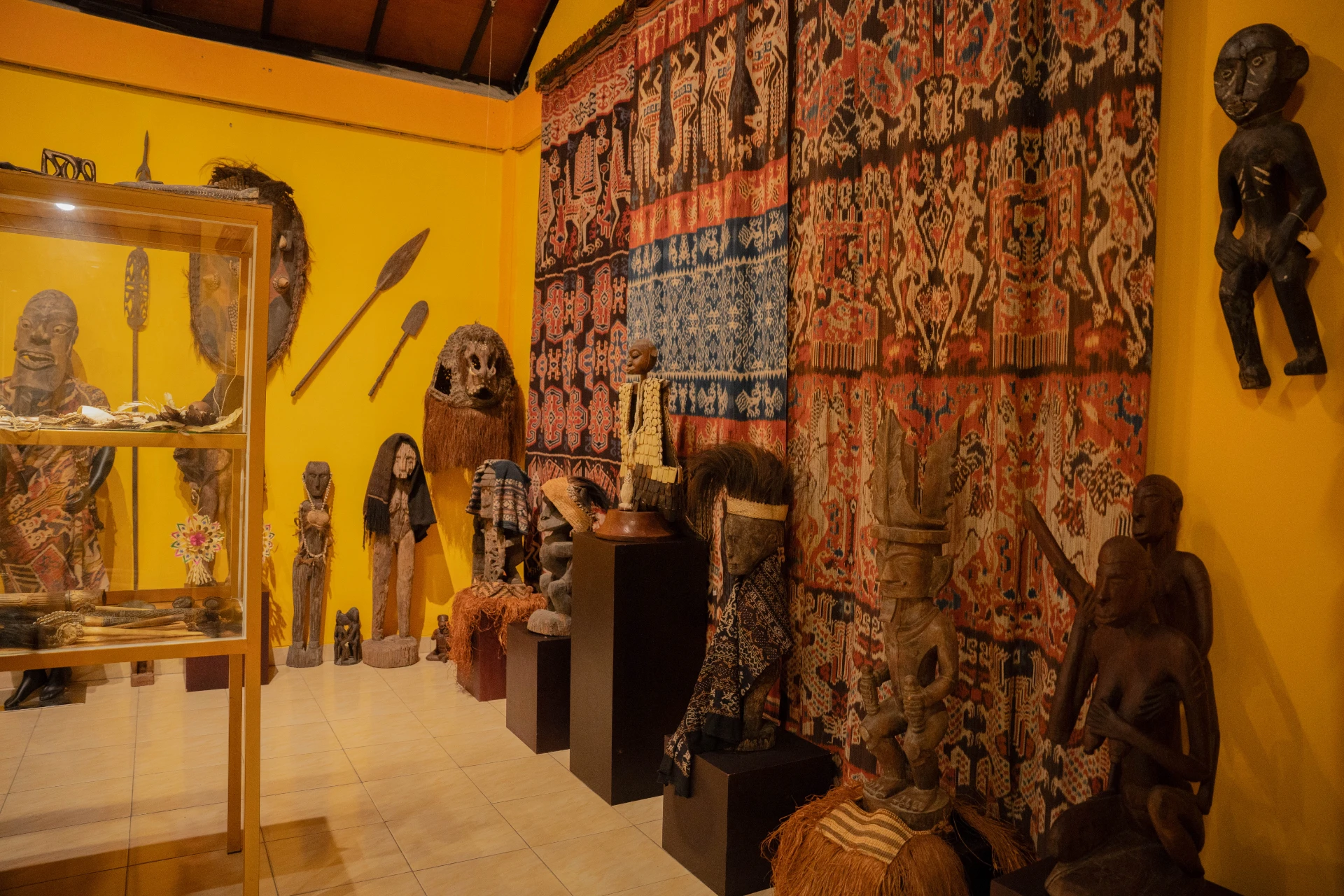 Small historical statues and spiritual sculptures related to Papua Eastern Indonesia collection in the Scary Room exhibit.