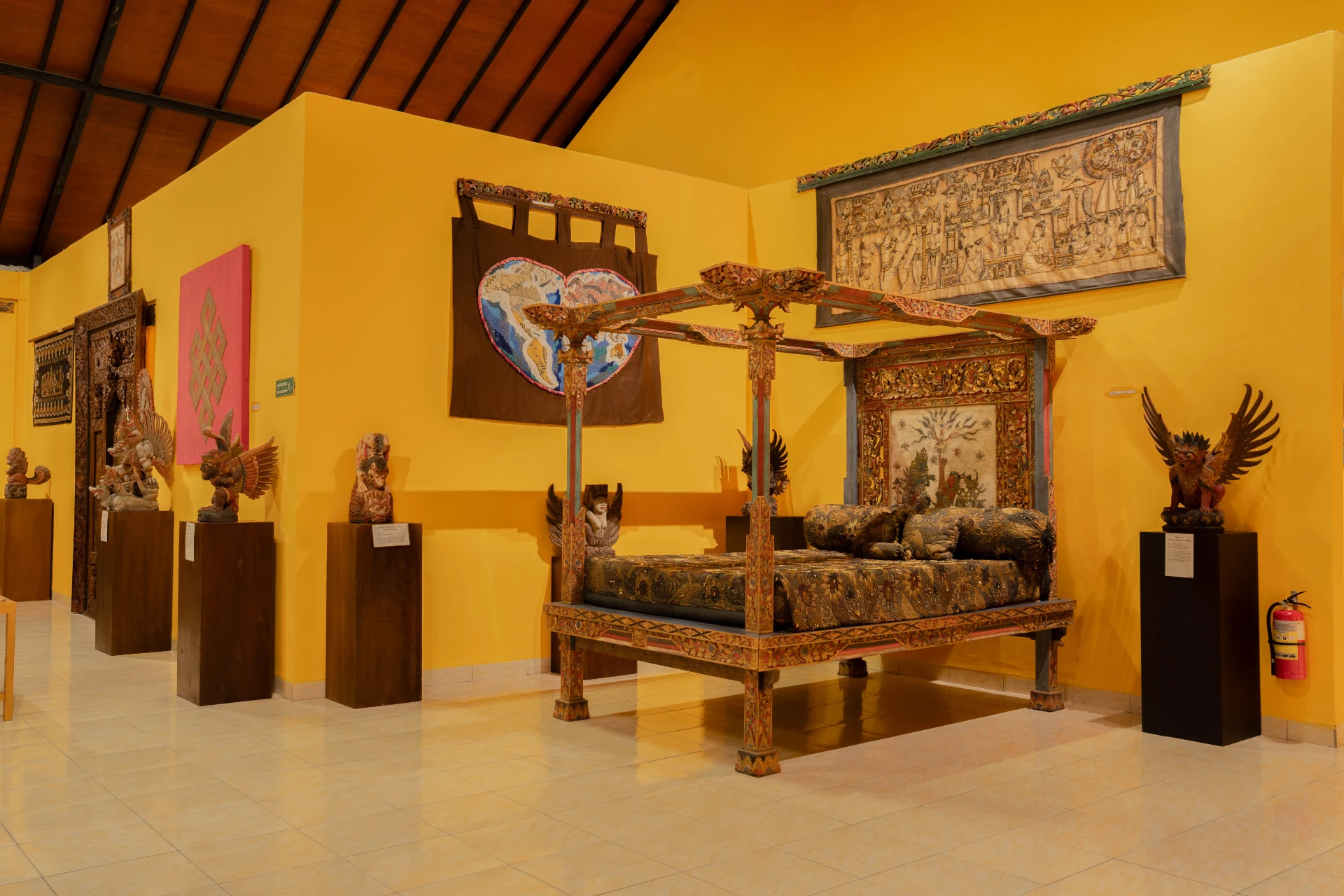 Collection of traditional Balinese textiles and ancient beaded jewelry fragments.