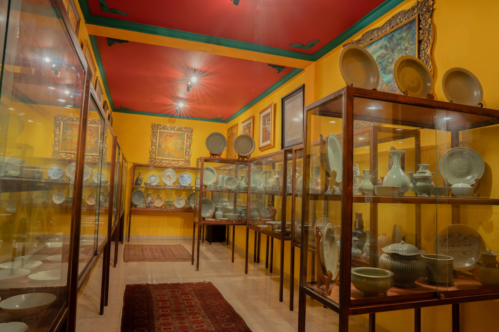 Curated glass display of Song Dynasty ceramic vases and historical vessels in the Song Room, Museum Peter Bloch Collection.