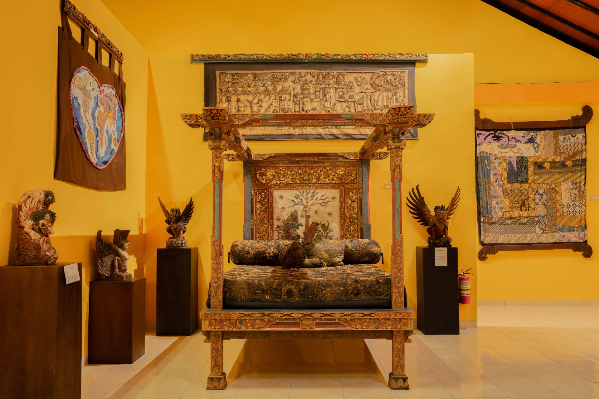 Collection of traditional Balinese textiles and ancient beaded jewelry fragments.