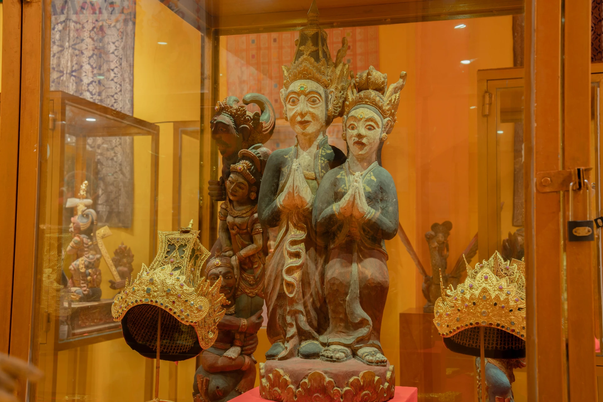 Collection of ancient gold earrings and small decorative ornaments in a museum display, Gold Room, Museum Peter Bloch Collection.